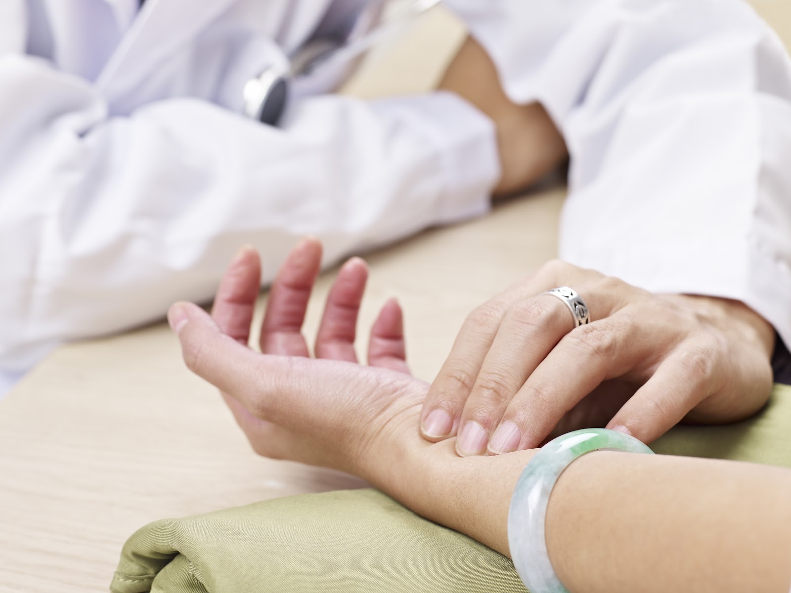 Traditional Chinese Medicine pulse diagnosis - Dr Reece Yeo examining patient's wrist pulse